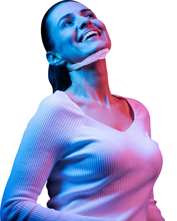 Woman smiling with a facial applicator under her chin at our Korte van Eeghenstraat clinic, EMface facial toning Amsterdam